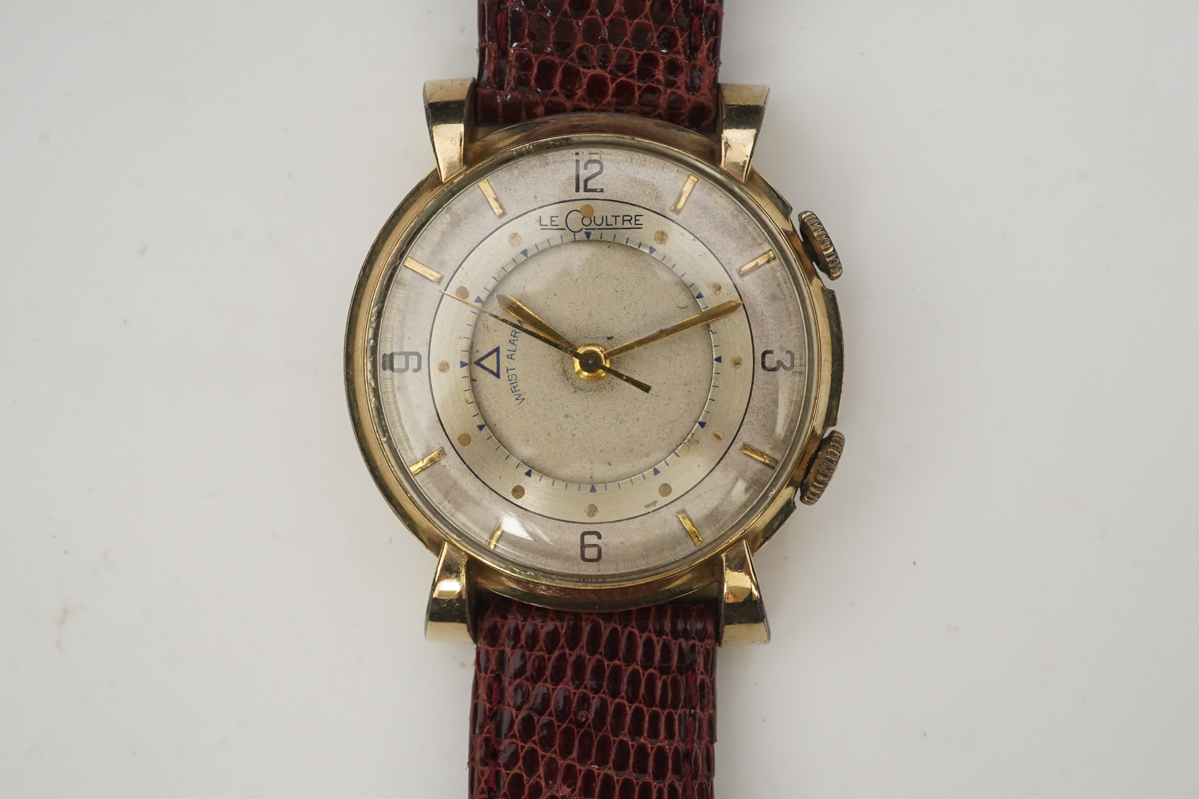 A gentleman's 1950's? 10k gold filled Jaeger LeCoultre Memovox manual wind wrist watch, on a later associated leather strap